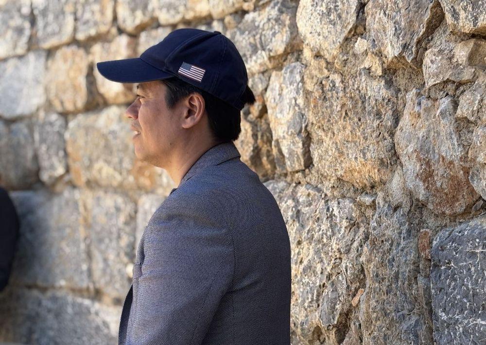Pastor Steve Cioccolanti standing by a rustic stone prayer wall in Turkey during a Discover Ministries tour