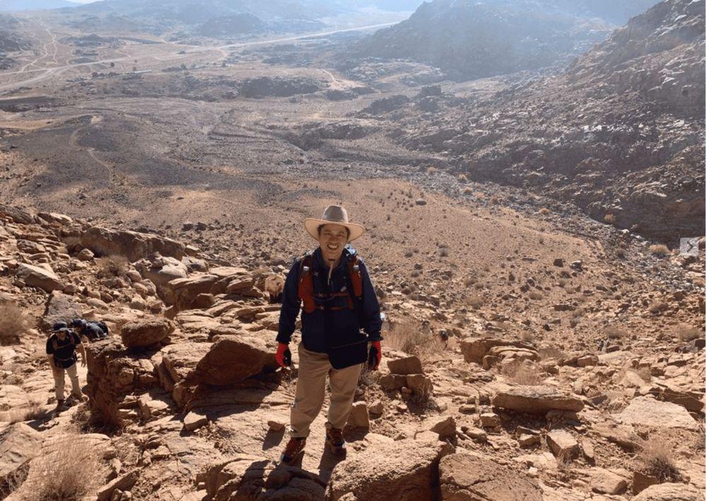 Pastor Steve Cioccolanti hiking through a desert landscape in Saudi Arabia during a 2023 ministry tour